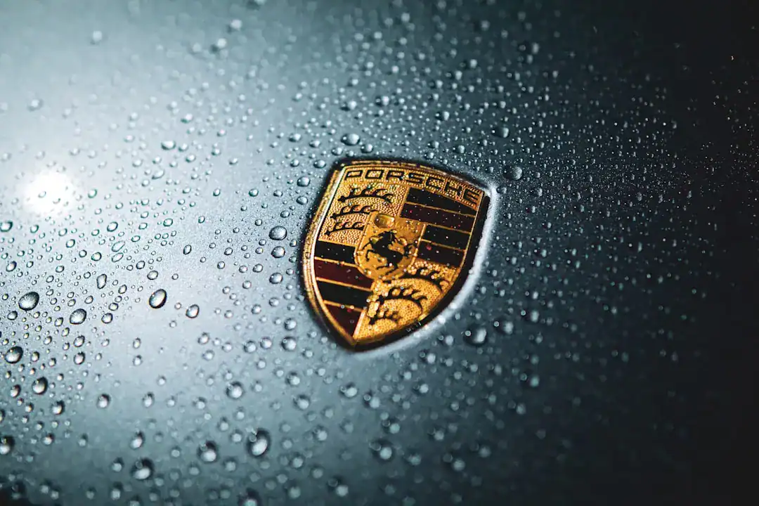 Illustration of Extreme close-up macro photography of the center of a Porsche car badge, focusing on the black.