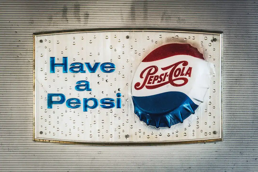 Retro Pepsi sign with bottle cap on a metal wall