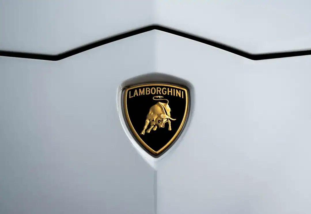 Illustration of Extreme close-up macro photography of the Lamborghini emblem on the hood of a luxury supercar..