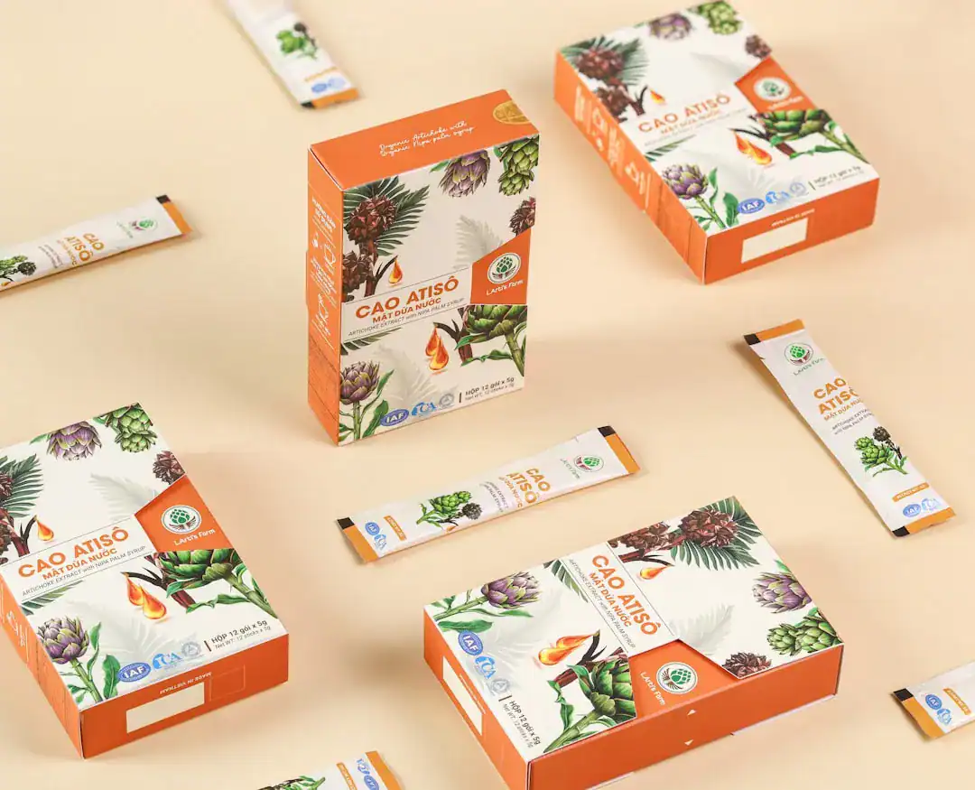 Assorted CAO ATISO boxes and sachets with botanical art on a beige background