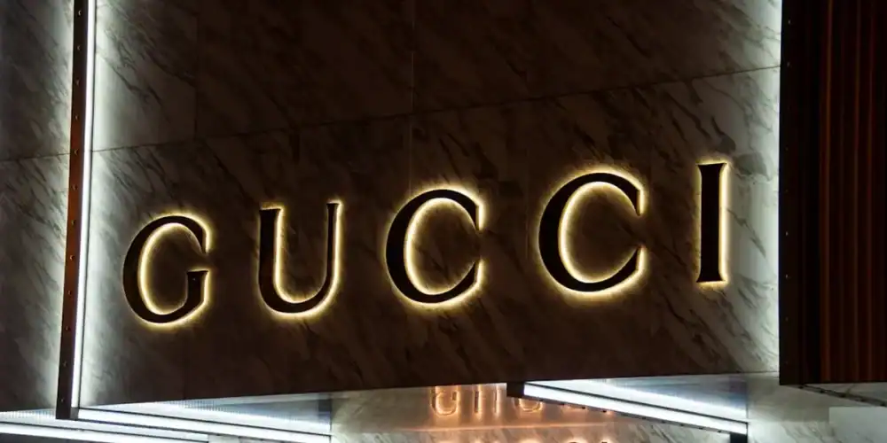 Gucci illuminated logo on marble storefront