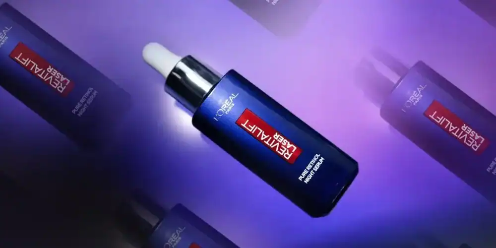 Blue Revitalift serum bottle with dropper on purple background