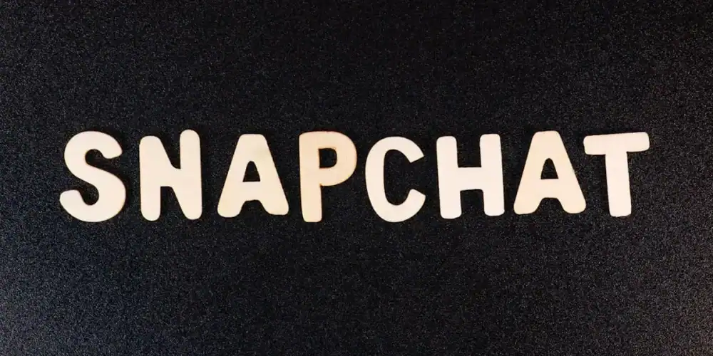 White SNAPCHAT lettering on dark textured background