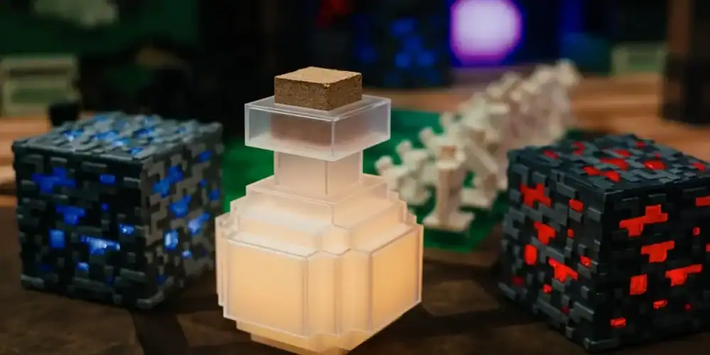 Frosted glass perfume bottle with cork stopper on a wooden table, beside voxel-pattern blocks.