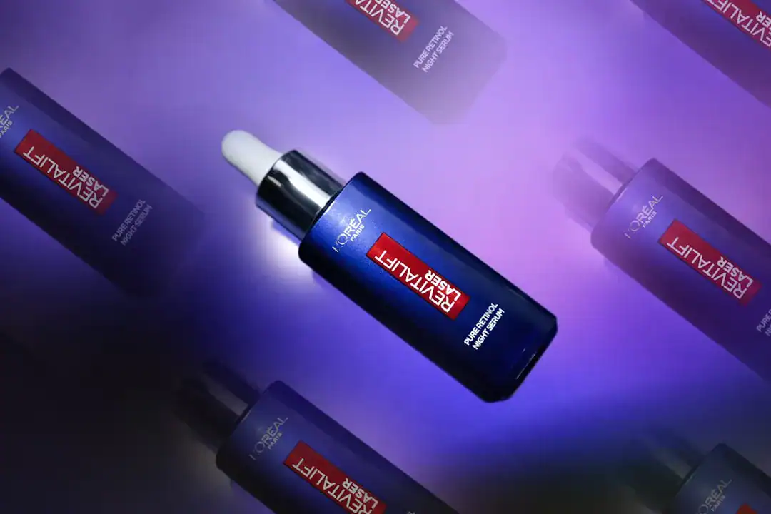 Blue Revitalift serum bottle with dropper on purple background