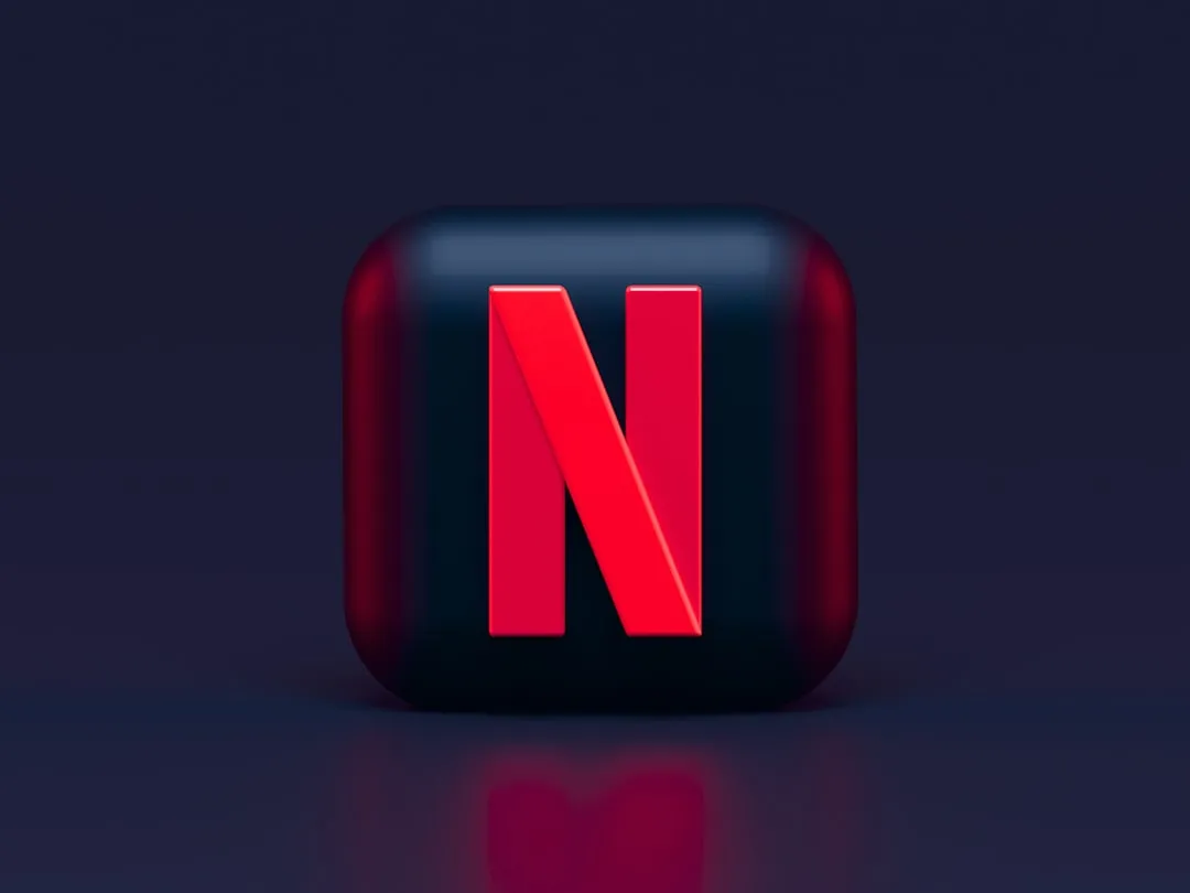 Netflix N logo on a glossy dark square with reflection