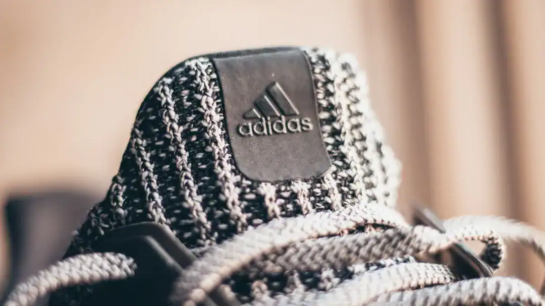 Close-up of Adidas knit sneaker tongue with logo