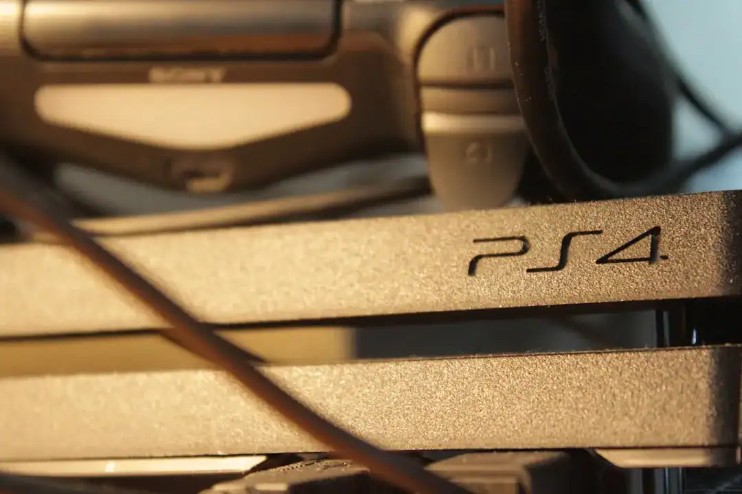 Close-up of a PS4 console with cables in the foreground