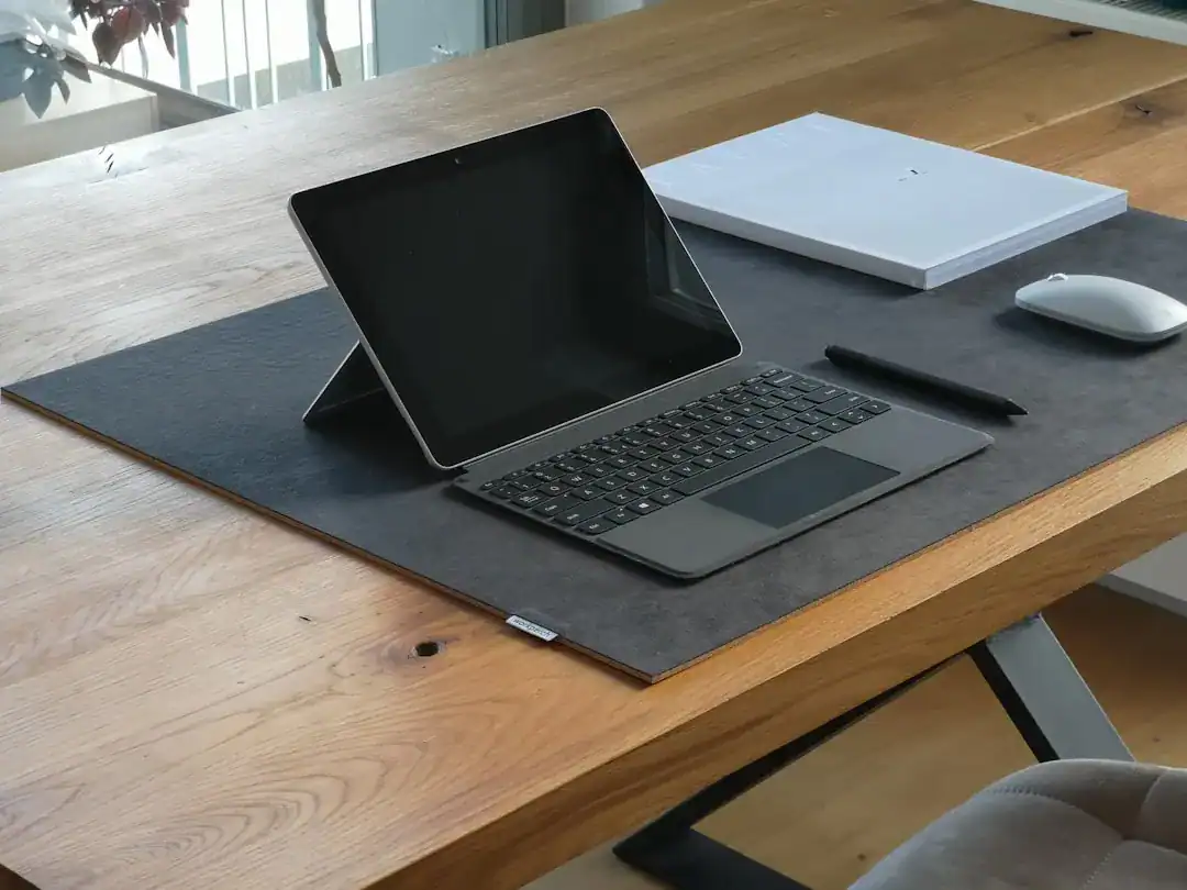 Tablet with keyboard on a wooden desk in a modern home office