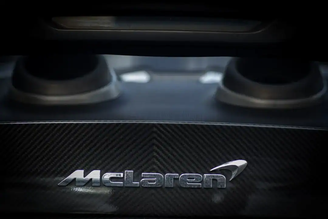 Close-up of McLaren logo on carbon fiber panel