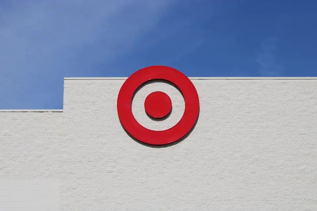 Red Target bullseye sign on white storefront against blue sky