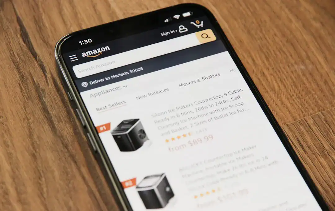 Mobile screen showing Amazon search results for appliances on a wooden table