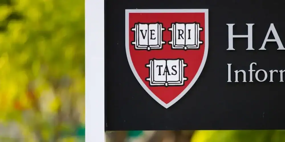 Close-up of Harvard information sign with Veritas shield on a red shield