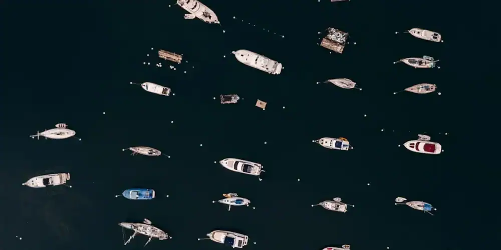 Aerial view of many boats on dark blue water