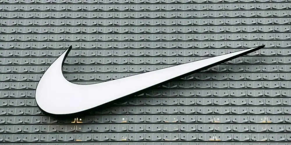 White Nike swoosh on grey tiled floor