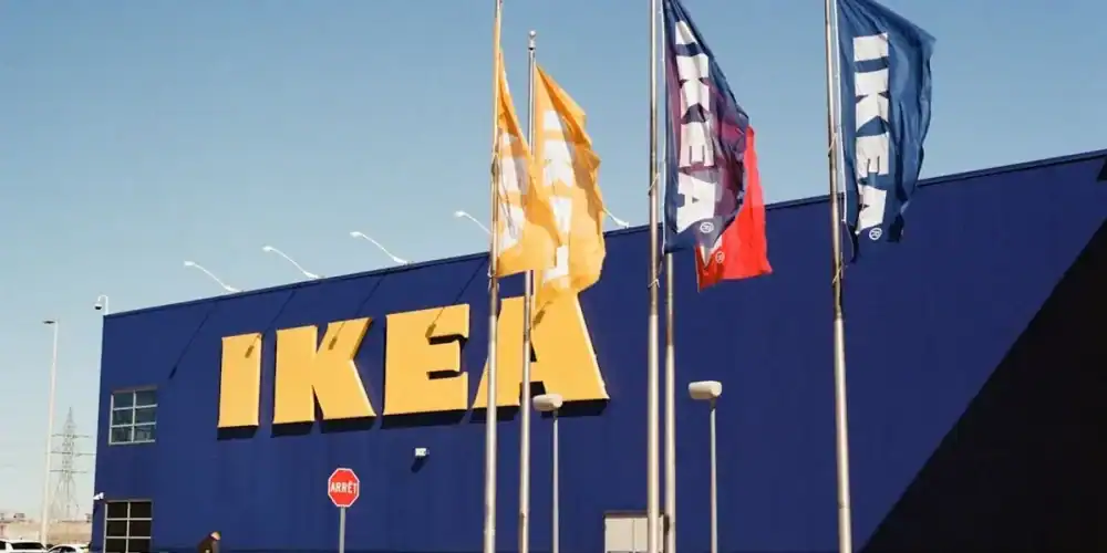 Blue IKEA storefront with large yellow logo and flagpoles
