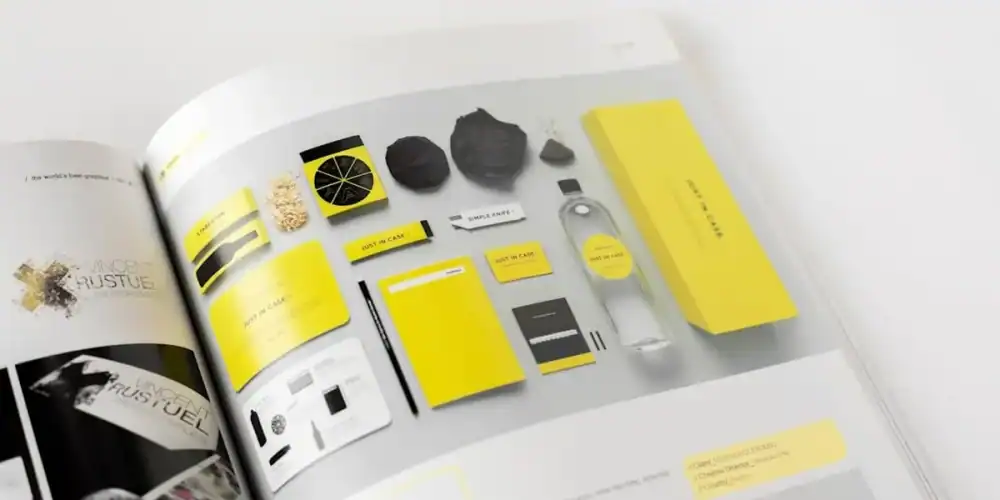 Open magazine spread with yellow and black branding items arranged in a grid.