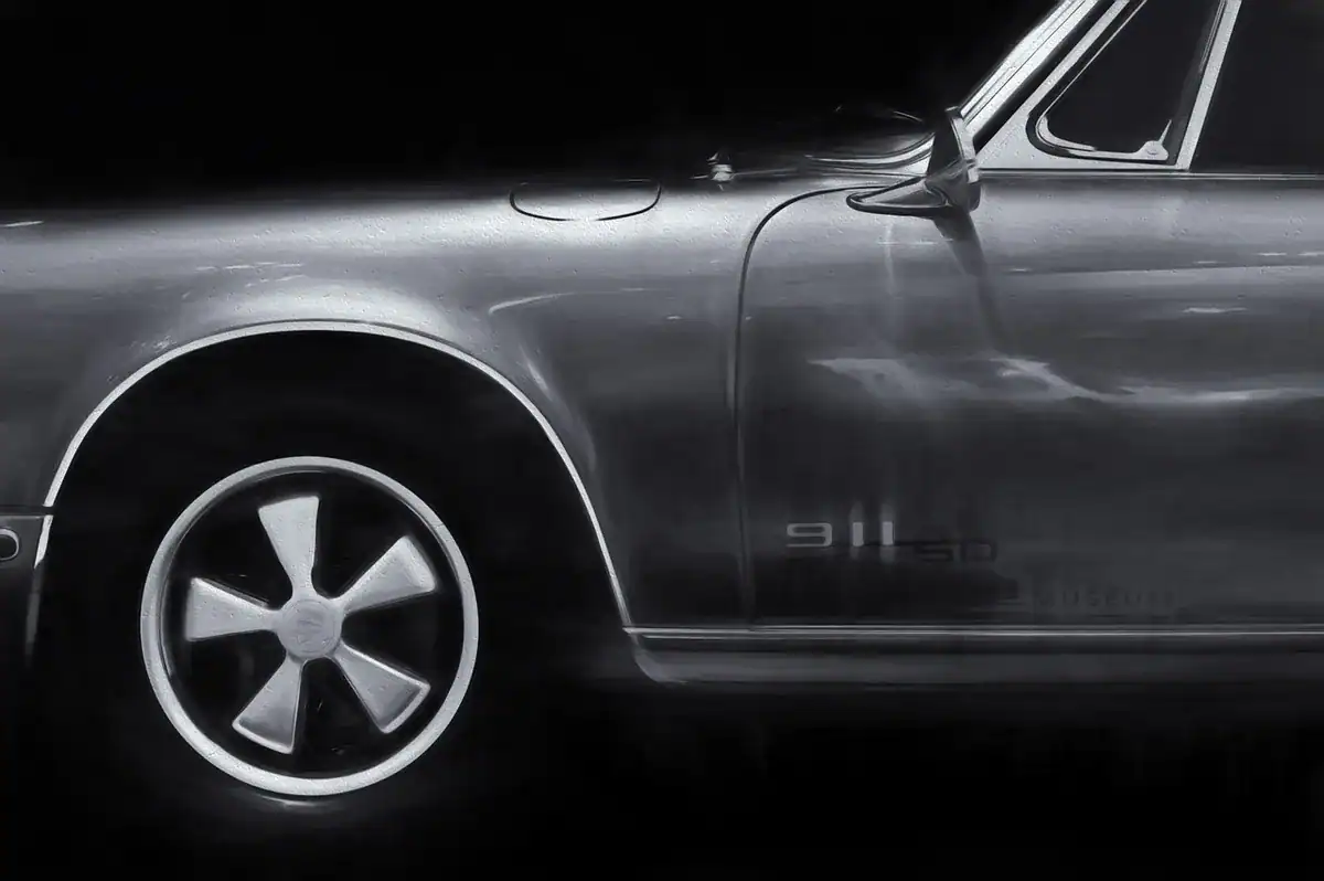 Vintage gray Porsche 911S side view with front wheel and door