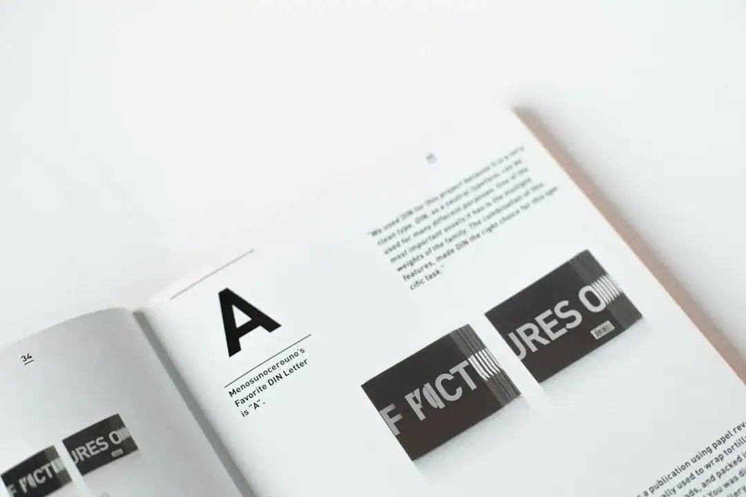 Open magazine on a white surface with a large A and black text blocks
