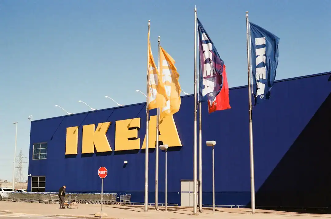 Blue IKEA storefront with large yellow logo and flagpoles