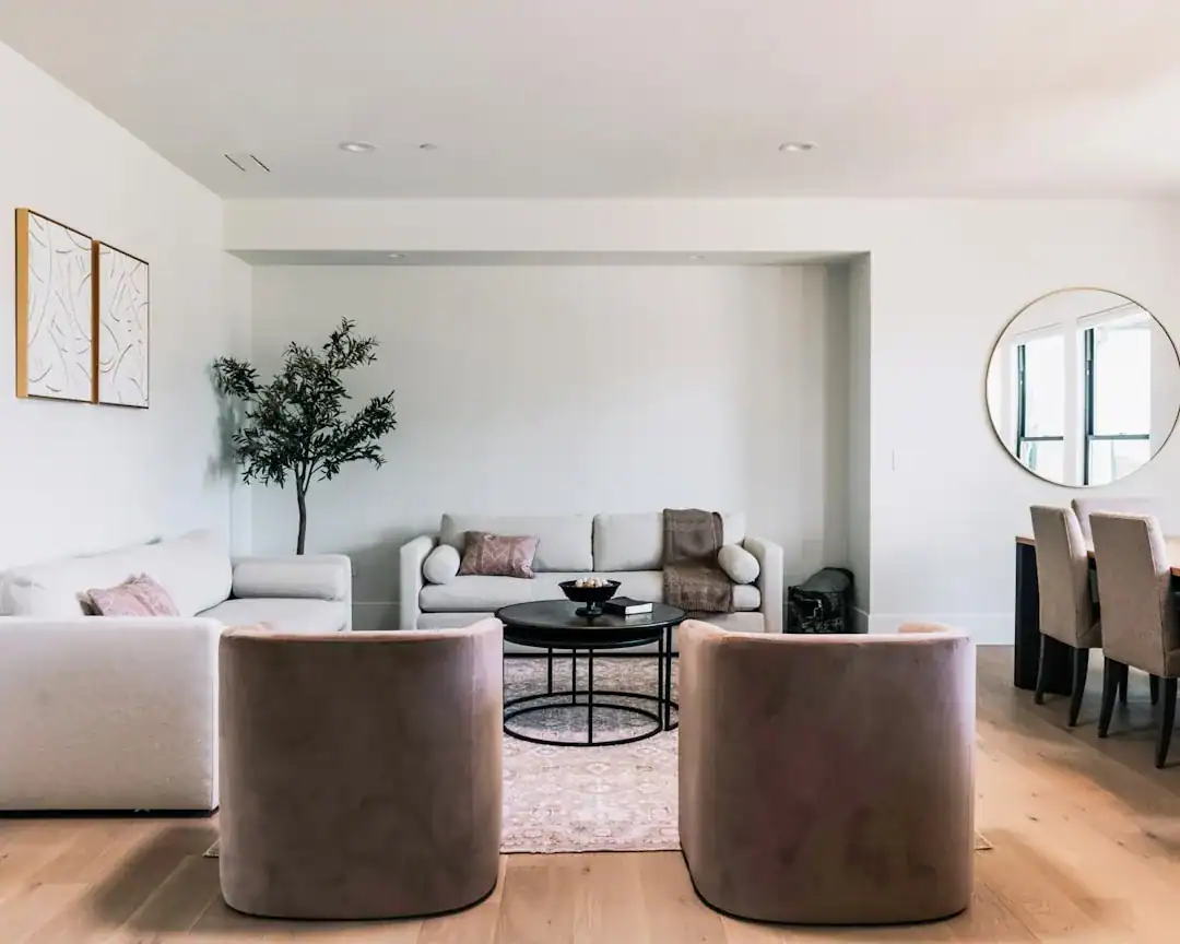 Bright modern living room with neutral furniture and plants