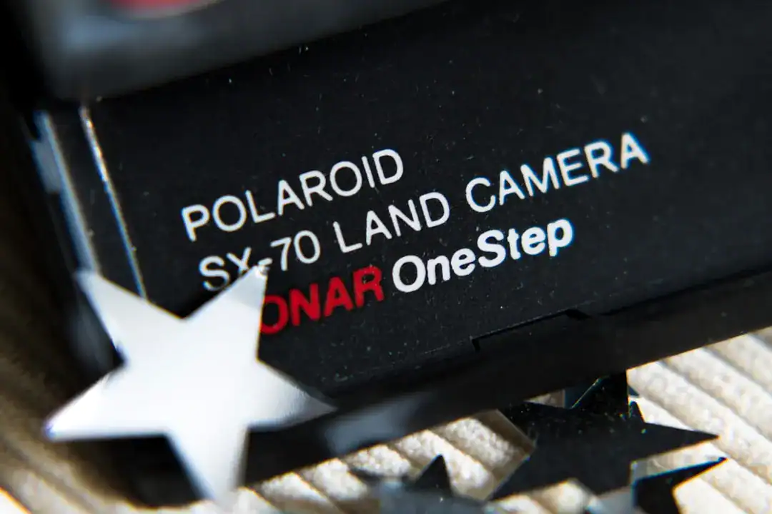 Close-up of Polaroid SX-70 camera label with star confetti