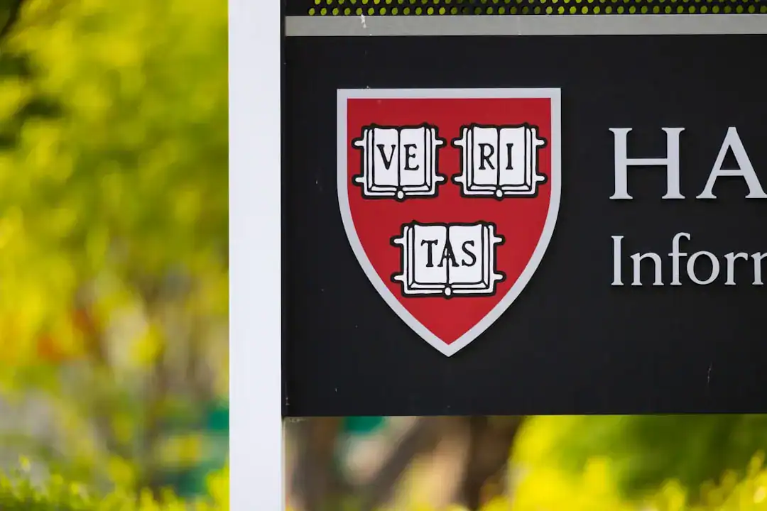 Close-up of Harvard information sign with Veritas shield on a red shield