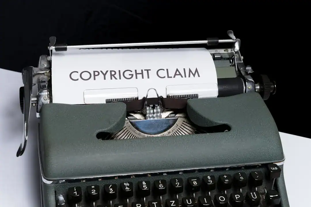 Green vintage typewriter with 'COPYRIGHT CLAIM' paper in carriage on a white surface